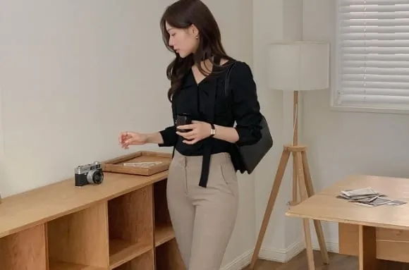 Công thức áo blouse màu đen và quần âu xám giúp chiều cao của người mặc sẽ được 