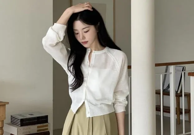 Sự kết hợp giữa áo cardigan trắng và quần màu be tạo nên vẻ ngoài sành điệu, trang nhã. 